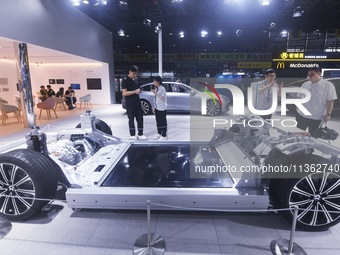 Visitors are visiting the NIO smart car chassis at the 2024 Mobile World Congress (MWC Shanghai) in Shanghai, China, on June 26, 2024. (