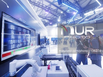 Visitors are visiting an ''AI+ Factory'' demonstration model at the 2024 Mobile World Congress (MWC Shanghai) in Shanghai, China, on June 26...