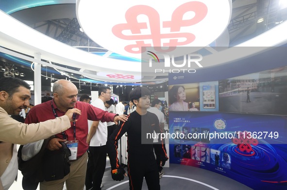 Foreign visitors are learning about China Unicom's digital people technology at the 2024 Mobile World Congress (MWC Shanghai) in Shanghai, C...