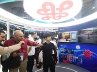 Foreign visitors are learning about China Unicom's digital people technology at the 2024 Mobile World Congress (MWC Shanghai) in Shanghai, C...