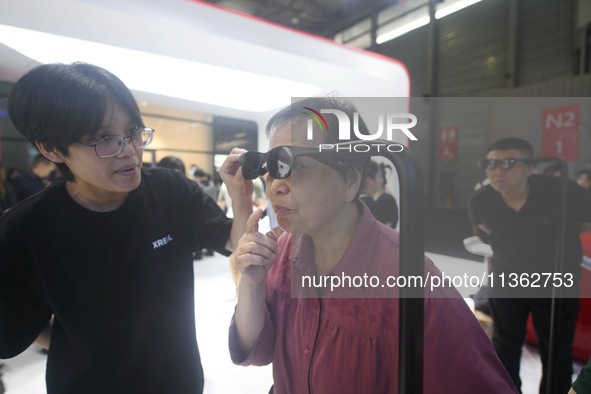 Foreign visitors are experiencing smart XR glasses at the 2024 Mobile World Congress (MWC Shanghai) in Shanghai, China, on June 26, 2024. 