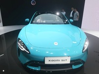 Foreign visitors are visiting the Xiaomi smart car SU7 at the 2024 Mobile World Congress (MWC Shanghai) in Shanghai, China, on June 26, 2024...