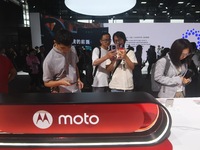 Foreign visitors are visiting the Xiaomi smart car SU7 at the 2024 Mobile World Congress (MWC Shanghai) in Shanghai, China, on June 26, 2024...