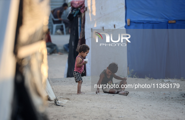 Displaced Palestinian children are playing at a camp for displaced Palestinians in Deir al-Balah, in the central Gaza Strip, on June 26, 202...