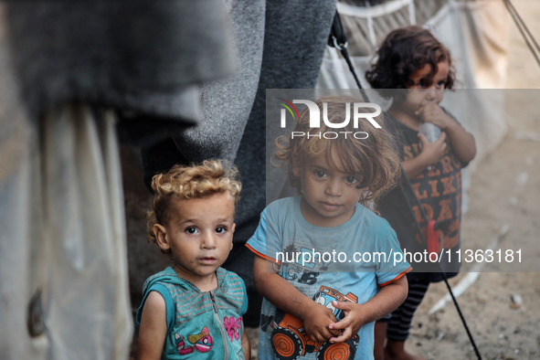 Displaced Palestinian children are staying at a camp for displaced Palestinians in Deir al-Balah, in the central Gaza Strip, on June 26, 202...