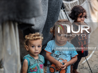 Displaced Palestinian children are staying at a camp for displaced Palestinians in Deir al-Balah, in the central Gaza Strip, on June 26, 202...