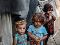 Displaced Palestinian children are staying at a camp for displaced Palestinians in Deir al-Balah, in the central Gaza Strip, on June 26, 202...