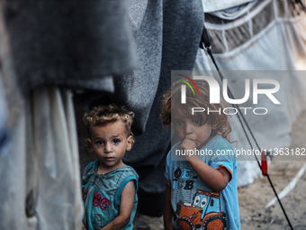 Displaced Palestinian children are staying at a camp for displaced Palestinians in Deir al-Balah, in the central Gaza Strip, on June 26, 202...