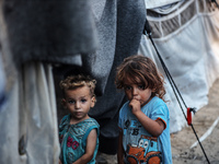 Displaced Palestinian children are staying at a camp for displaced Palestinians in Deir al-Balah, in the central Gaza Strip, on June 26, 202...