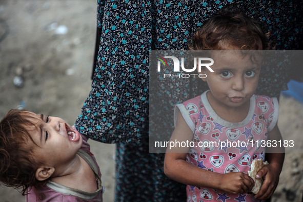 Displaced Palestinian children are staying at a camp for displaced Palestinians in Deir al-Balah, in the central Gaza Strip, on June 26, 202...