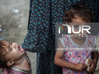 Displaced Palestinian children are staying at a camp for displaced Palestinians in Deir al-Balah, in the central Gaza Strip, on June 26, 202...