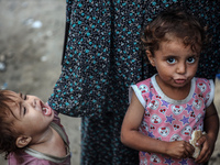 Displaced Palestinian children are staying at a camp for displaced Palestinians in Deir al-Balah, in the central Gaza Strip, on June 26, 202...