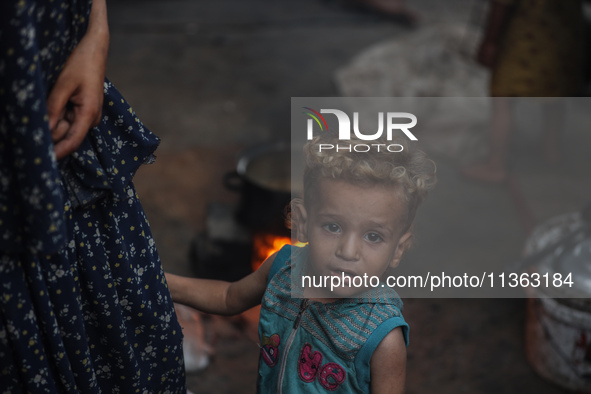 Displaced Palestinian children are staying at a camp for displaced Palestinians in Deir al-Balah, in the central Gaza Strip, on June 26, 202...