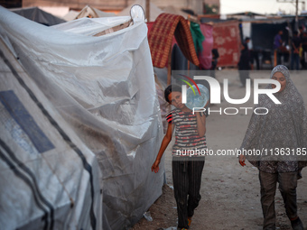 Displaced Palestinian girls are being seen at a camp for displaced Palestinians in Deir al-Balah, in the central Gaza Strip, on June 26, 202...