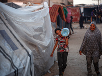 Displaced Palestinian girls are being seen at a camp for displaced Palestinians in Deir al-Balah, in the central Gaza Strip, on June 26, 202...