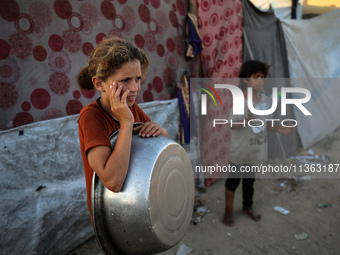 Displaced Palestinian girls are being seen at a camp for displaced Palestinians in Deir al-Balah, in the central Gaza Strip, on June 26, 202...