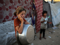 Displaced Palestinian girls are being seen at a camp for displaced Palestinians in Deir al-Balah, in the central Gaza Strip, on June 26, 202...