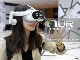 Visitors are experiencing a large-scale Space Exploration VR immersive exhibition in Suzhou, China, on June 26, 2024. (