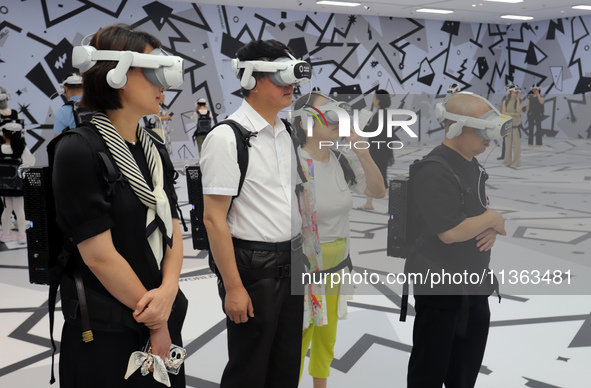 Visitors are experiencing a large-scale Space Exploration VR immersive exhibition in Suzhou, China, on June 26, 2024. 