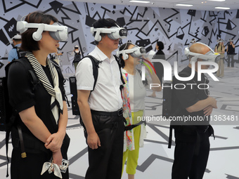 Visitors are experiencing a large-scale Space Exploration VR immersive exhibition in Suzhou, China, on June 26, 2024. (