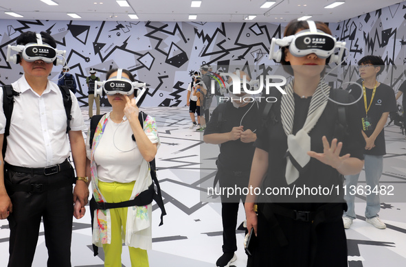 Visitors are experiencing a large-scale Space Exploration VR immersive exhibition in Suzhou, China, on June 26, 2024. 