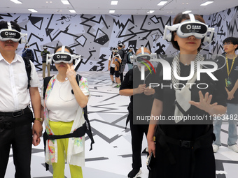 Visitors are experiencing a large-scale Space Exploration VR immersive exhibition in Suzhou, China, on June 26, 2024. (