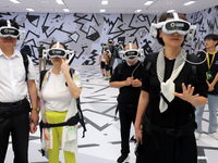 Visitors are experiencing a large-scale Space Exploration VR immersive exhibition in Suzhou, China, on June 26, 2024. (