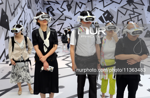 Visitors are experiencing a large-scale Space Exploration VR immersive exhibition in Suzhou, China, on June 26, 2024. 