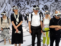 Visitors are experiencing a large-scale Space Exploration VR immersive exhibition in Suzhou, China, on June 26, 2024. (