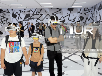 Visitors are experiencing a large-scale Space Exploration VR immersive exhibition in Suzhou, China, on June 26, 2024. (