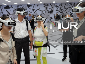 Visitors are experiencing a large-scale Space Exploration VR immersive exhibition in Suzhou, China, on June 26, 2024. (