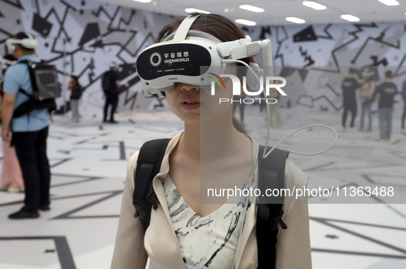 Visitors are experiencing a large-scale Space Exploration VR immersive exhibition in Suzhou, China, on June 26, 2024. 