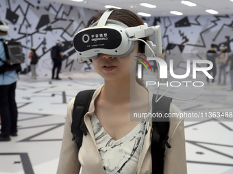 Visitors are experiencing a large-scale Space Exploration VR immersive exhibition in Suzhou, China, on June 26, 2024. (