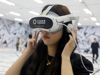 Visitors are experiencing a large-scale Space Exploration VR immersive exhibition in Suzhou, China, on June 26, 2024. (