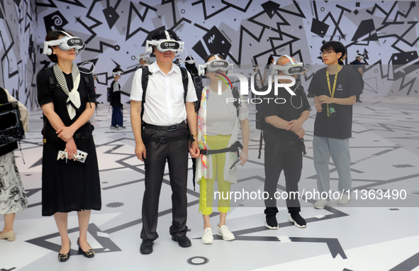 Visitors are experiencing a large-scale Space Exploration VR immersive exhibition in Suzhou, China, on June 26, 2024. 