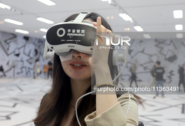 Visitors are experiencing a large-scale Space Exploration VR immersive exhibition in Suzhou, China, on June 26, 2024. 