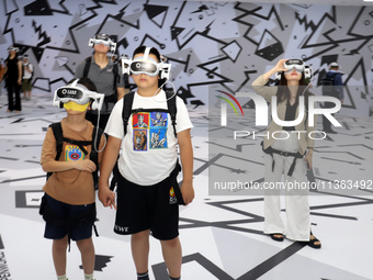 Visitors are experiencing a large-scale Space Exploration VR immersive exhibition in Suzhou, China, on June 26, 2024. (