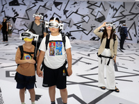 Visitors are experiencing a large-scale Space Exploration VR immersive exhibition in Suzhou, China, on June 26, 2024. (