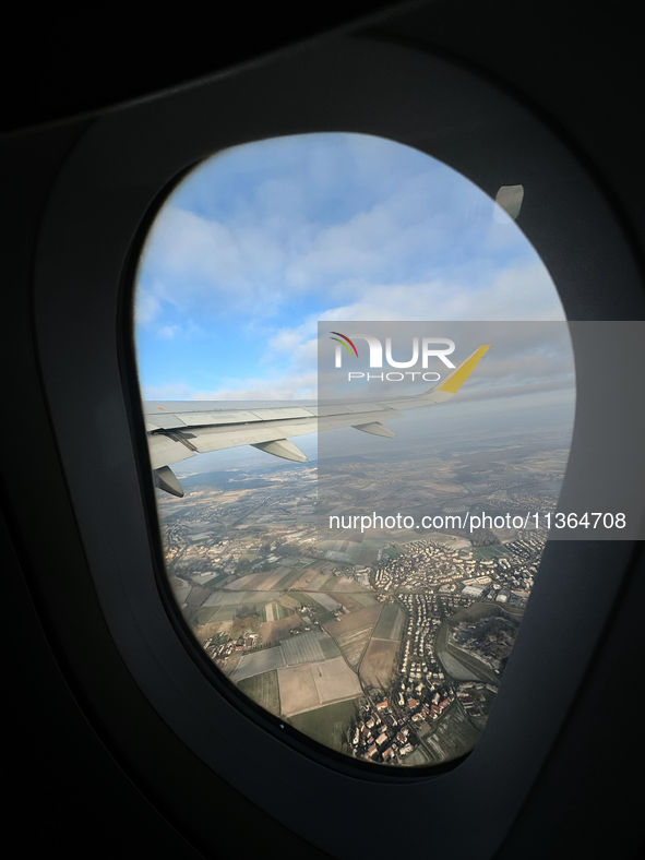 Clouds are appearing on the horizon, viewed from the window of an Airbus A321 from Vueling Airlines in Zurich, Switzerland, on June 27, 2024...