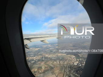 Clouds are appearing on the horizon, viewed from the window of an Airbus A321 from Vueling Airlines in Zurich, Switzerland, on June 27, 2024...