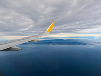 Clouds are appearing on the horizon, viewed from the window of an Airbus A321 from Vueling Airlines in Zurich, Switzerland, on June 27, 2024...