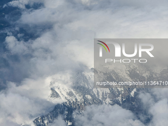 Clouds are appearing on the horizon, viewed from the window of an Airbus A321 from Vueling Airlines in Zurich, Switzerland, on June 27, 2024...