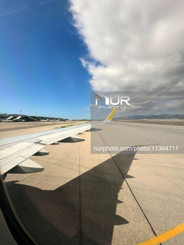 Clouds are appearing on the horizon, viewed from the window of an Airbus A321 from Vueling Airlines in Zurich, Switzerland, on June 27, 2024...