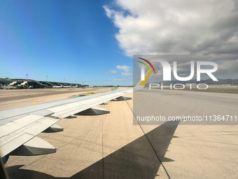 Clouds are appearing on the horizon, viewed from the window of an Airbus A321 from Vueling Airlines in Zurich, Switzerland, on June 27, 2024...