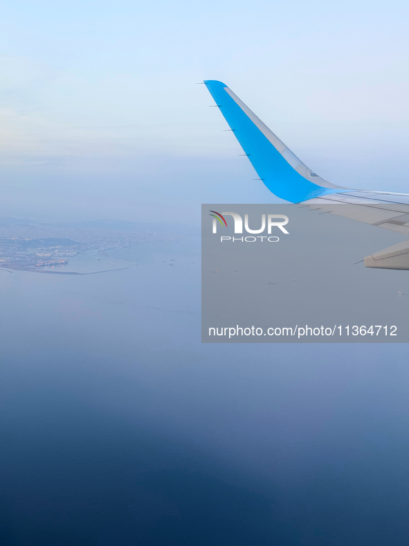 Clouds are appearing on the horizon, viewed from the window of an Airbus A321 from Vueling Airlines in Zurich, Switzerland, on June 27, 2024...