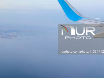 Clouds are appearing on the horizon, viewed from the window of an Airbus A321 from Vueling Airlines in Zurich, Switzerland, on June 27, 2024...