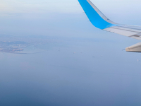 Clouds are appearing on the horizon, viewed from the window of an Airbus A321 from Vueling Airlines in Zurich, Switzerland, on June 27, 2024...