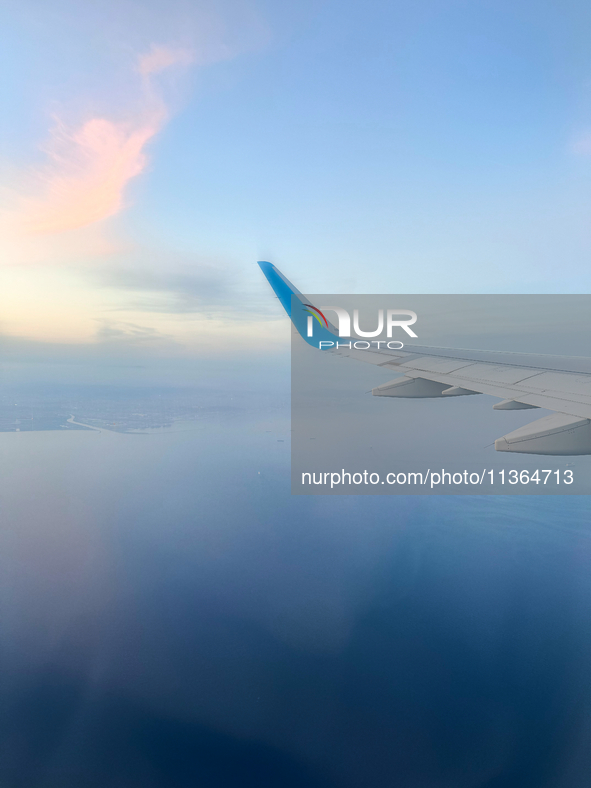 Clouds are appearing on the horizon, viewed from the window of an Airbus A321 from Vueling Airlines in Zurich, Switzerland, on June 27, 2024...