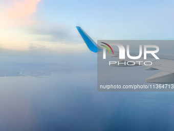 Clouds are appearing on the horizon, viewed from the window of an Airbus A321 from Vueling Airlines in Zurich, Switzerland, on June 27, 2024...