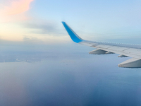 Clouds are appearing on the horizon, viewed from the window of an Airbus A321 from Vueling Airlines in Zurich, Switzerland, on June 27, 2024...